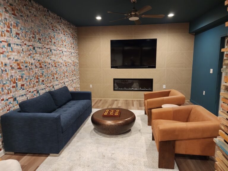 Spacious, remodeled basement with home theater setup.