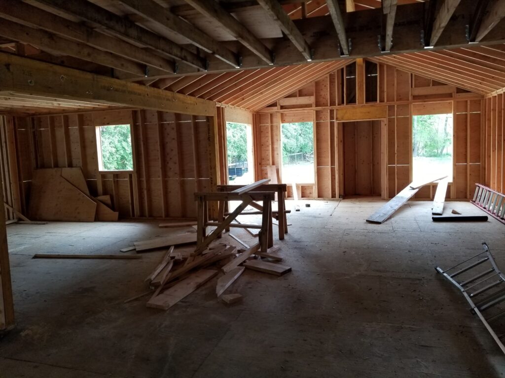 Image of a house with dormers and additions under construction