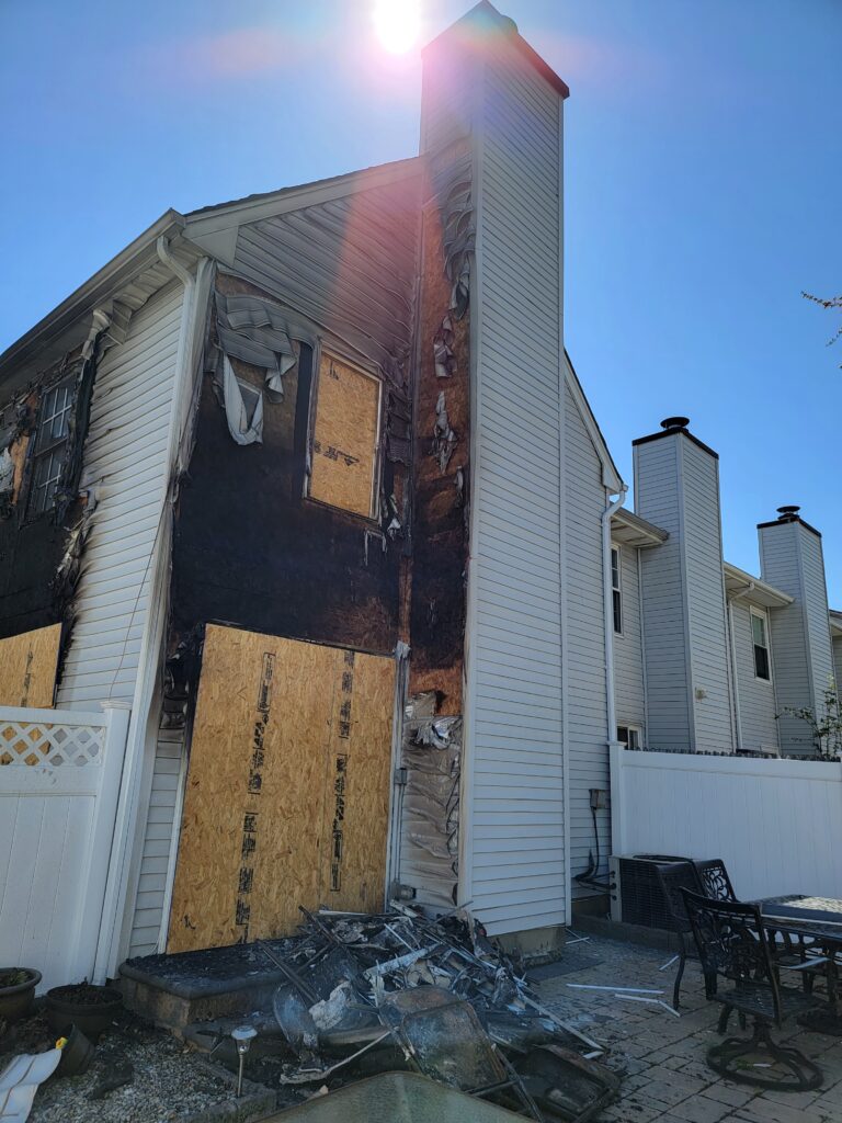 Burnt wall of a house being assessed for emergency board ups after fire damage.